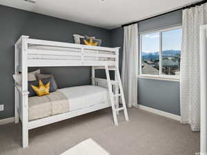 Carpeted bedroom featuring a mountain view
