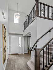 Foyer entrance featuring hardwood / wood-style flooring and a high ceiling