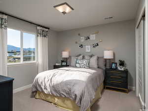 Carpeted bedroom with a mountain view