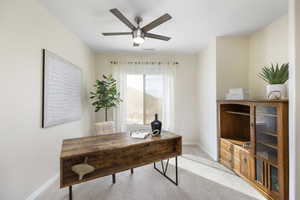 Carpeted office space with ceiling fan