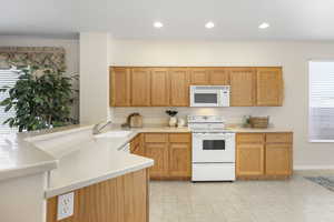 Kitchen with sink and white appliances