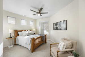 Carpeted bedroom featuring ceiling fan