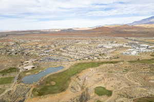 Birds eye view of property with a water and mountain view