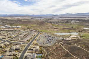 Drone / aerial view featuring a water and mountain view