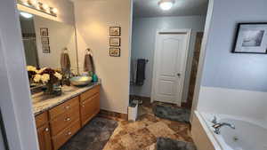 Bathroom with vanity and a bathing tub