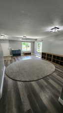 Interior space featuring wood-type flooring and a textured ceiling