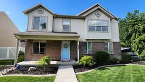 View of front of property featuring a front lawn and a porch