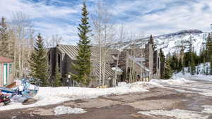 View of snow covered exterior featuring a mountain view