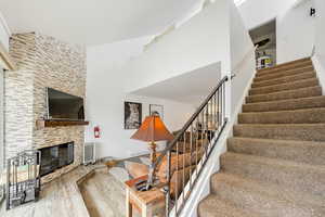 Living room featuring radiator, hardwood / wood-style floors, and a large fireplace