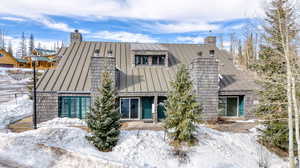 View of snow covered back of property