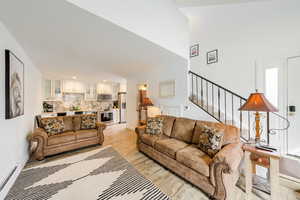 Living room featuring a baseboard radiator and light hardwood / wood-style flooring