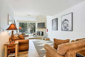 Living room featuring hardwood / wood-style flooring and a fireplace