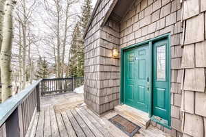 Doorway to property featuring a deck