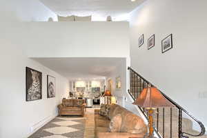 Living room with a baseboard heating unit and light hardwood / wood-style flooring