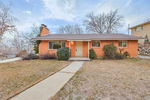 Ranch-style home with a front lawn