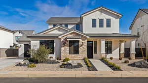 View of front of house with a garage and covered porch