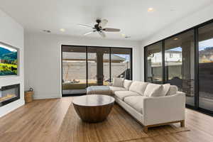 Living room featuring ceiling fan and light hardwood / wood-style flooring