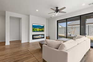 Living room with hardwood / wood-style floors and ceiling fan