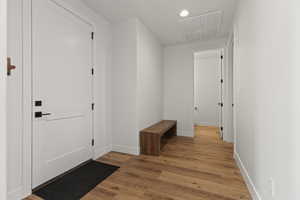 Corridor with light hardwood / wood-style flooring