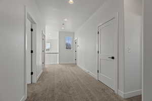 Corridor with light colored carpet