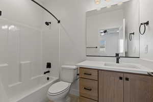 Full bathroom with shower / washtub combination, toilet, and vanity