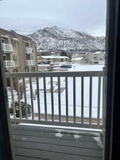 Snow covered deck featuring a mountain view