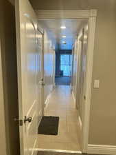 Hallway with light tile patterned floors