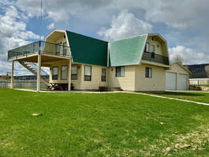 Front of house featuring a garage and a yard