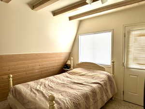 Bedroom with beamed ceiling and carpet