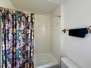 Owner suite bathroom with toilet and shower / bath combo