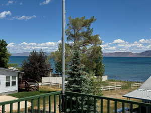 Water view from deck featuring a mountain view