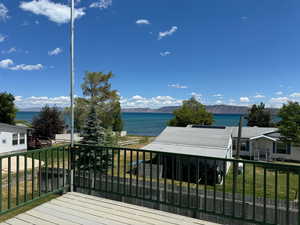 Wooden deck with a water and mountain view