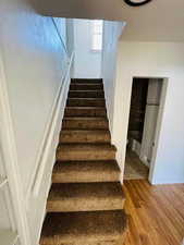 Stairway with hardwood / wood-style flooring