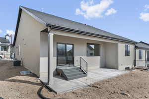 Back of house featuring a patio area and stucco siding