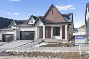 View of front of house with a garage and covered porch