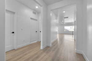 Corridor featuring light hardwood / wood-style flooring