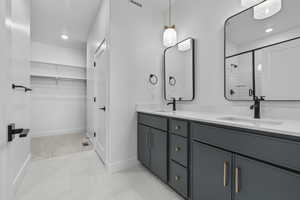 Bathroom with vanity and a shower with door