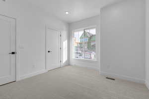 Spare room with light colored carpet