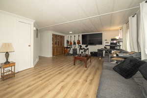 Living room featuring crown molding and light hardwood / wood-style floors