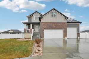 Craftsman house with a porch, a garage, and a front yard