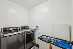 Washroom with tile patterned floors and independent washer and dryer