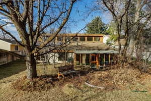 Back of property with a sunroom