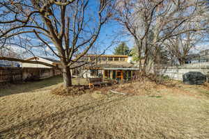 Back of house with a lawn