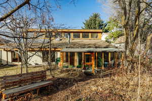 Rear view of property featuring a sunroom