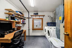 Washroom featuring washing machine and clothes dryer