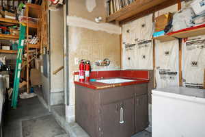 Bathroom featuring sink and concrete floors