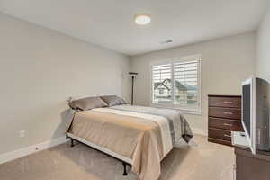 Bedroom with light carpet