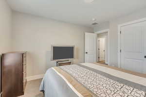 Bedroom with light colored carpet