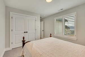 Bedroom featuring a closet and light carpet