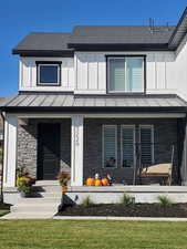 Exterior space featuring a front lawn and a porch
